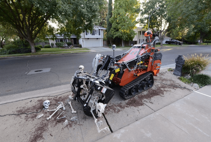 Anderson Halloween House — skeleton on a Ditch Witch