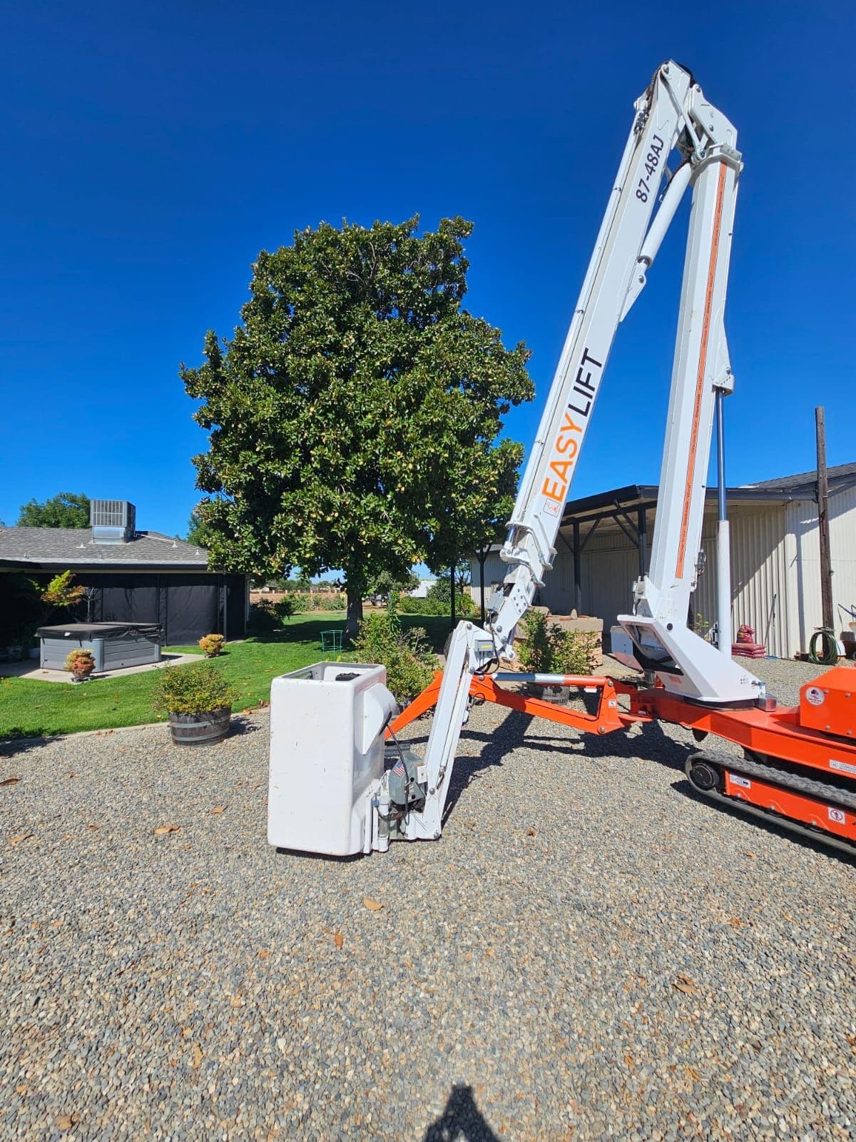Professional aerial equipment beside a mature tree for inspection